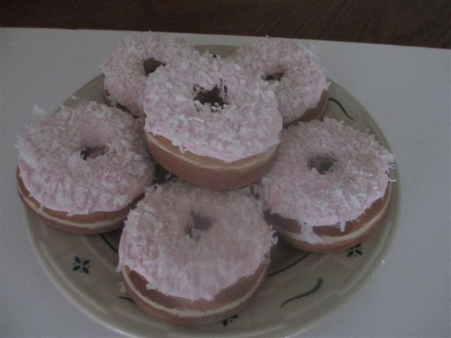 Light Strawberry frosted Coconut topped Raised Donuts