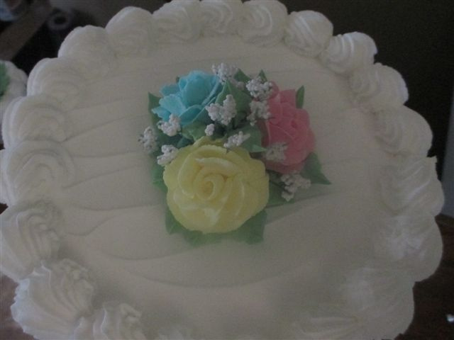 White Designed cake with Pastel Flowers