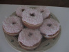 Light Strawberry frosted Coconut topped Raised Donuts