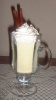 Eggnog topped with whipped cream and cinnamon sticks                              